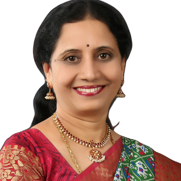 Studio portrait of Dr. P. Lakshmi Satish in a red and gold saree.